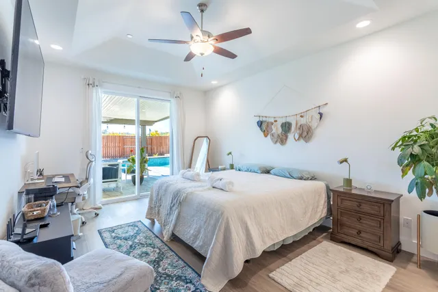 a bedroom with a large bed and a chandelier