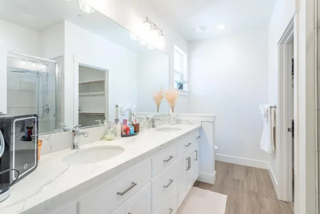 a bathroom with a double vanity sink mirror and double