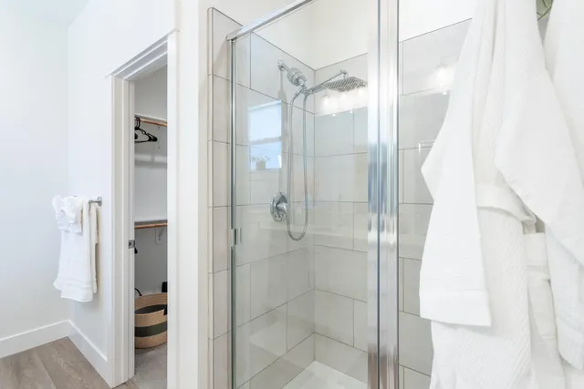 a bathroom with a glass shower door and a bathroom