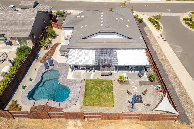 an aerial view of a house with a swimming pool