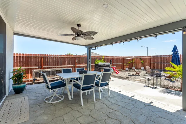 a view of a dinning table and chairs in the patio