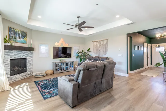 a living room with furniture a flat screen tv and a fireplace