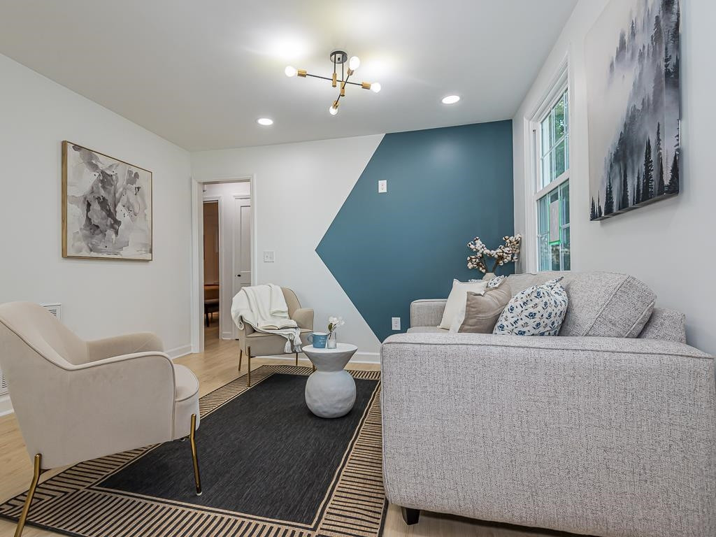 1703 Patton Road Raleigh, NC 27608 - Photo 12 of 30 a living room with furniture and a rug