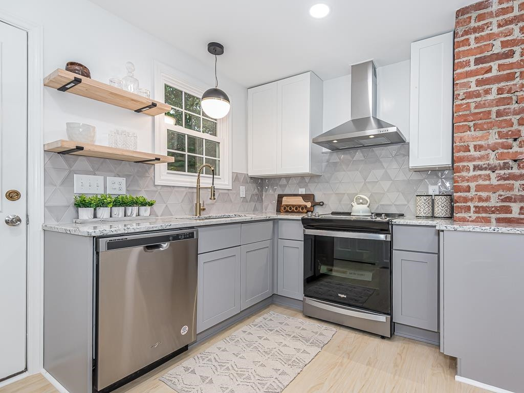 1703 Patton Road Raleigh, NC 27608 - Photo 2 of 30 a kitchen with stainless steel appliances granite countertop a stove and a sink