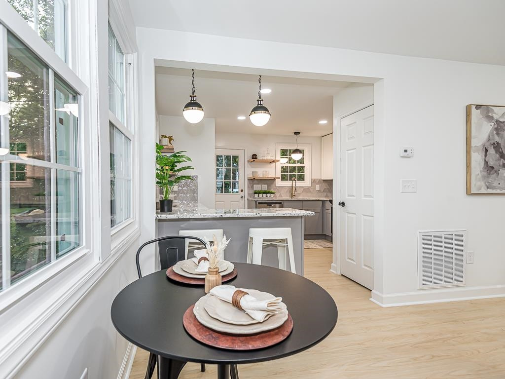 1703 Patton Road Raleigh, NC 27608 - Photo 6 of 30 a kitchen with a table and chairs