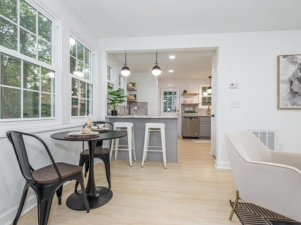 1703 Patton Road Raleigh, NC 27608 - Photo 7 of 30 a view of a dining room with furniture and a large window