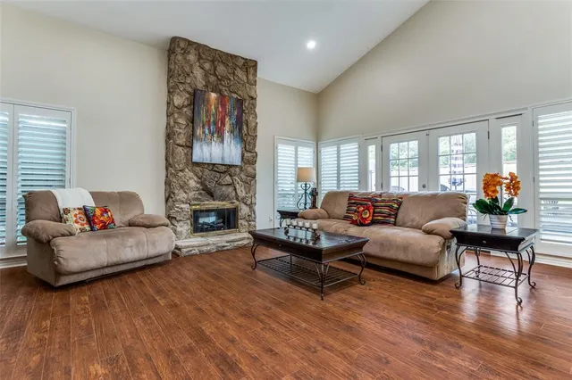 a living room with fireplace furniture and a wooden floor
