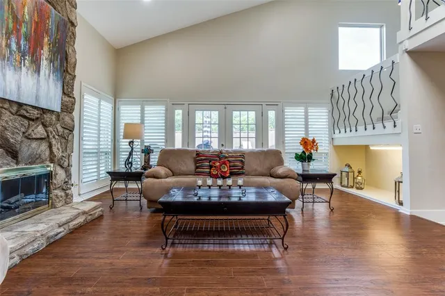 a living room with furniture a fireplace and a large window