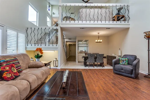 a living room with furniture and a chandelier