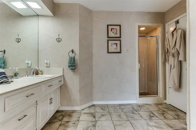 a bathroom with a double vanity sink a toilet and a shower