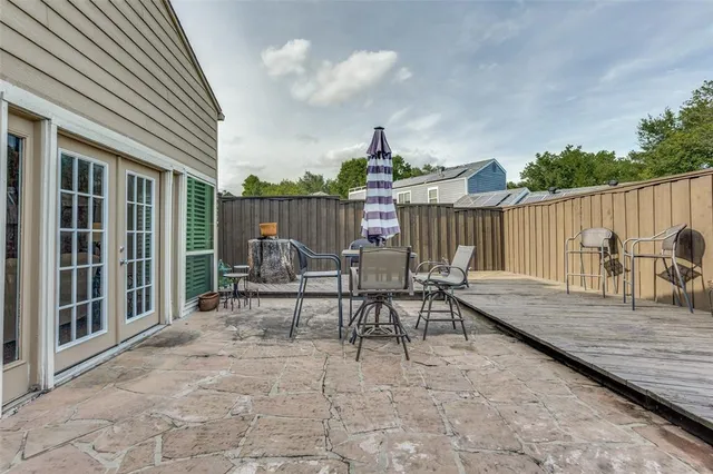 a view of a chair and tables in the patio
