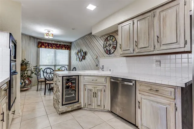 a kitchen with stainless steel appliances granite countertop a stove and cabinets