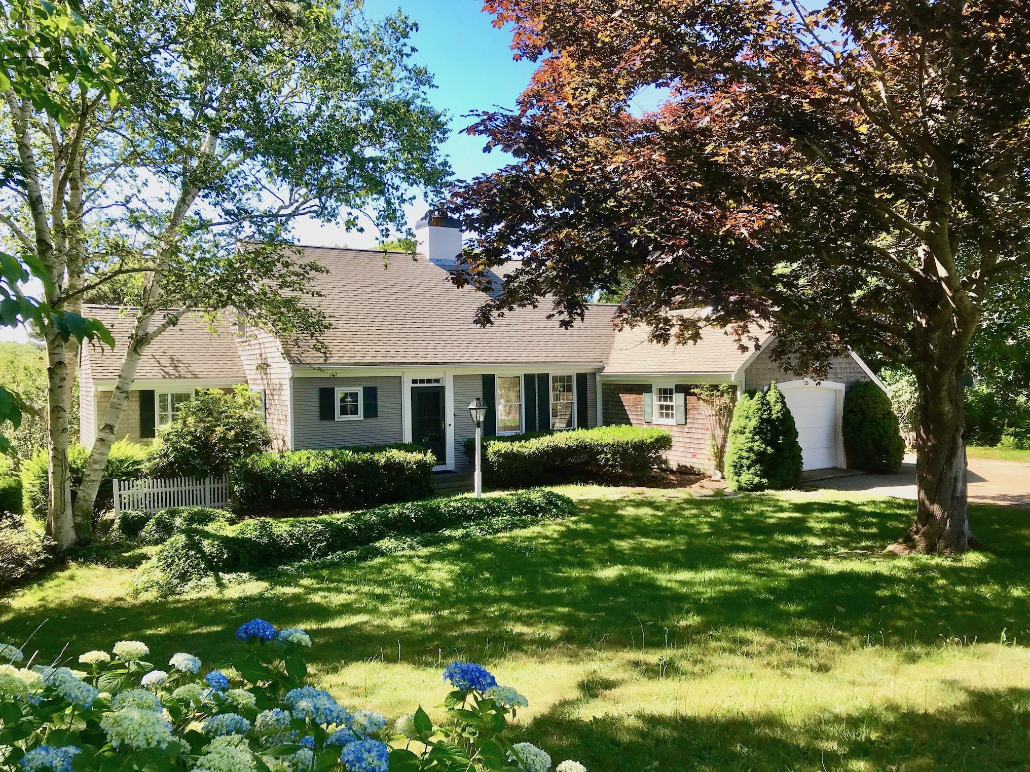 26 Champlain Road Orleans, MA 02653 - Photo 1 of 32 a front view of house with yard and green space