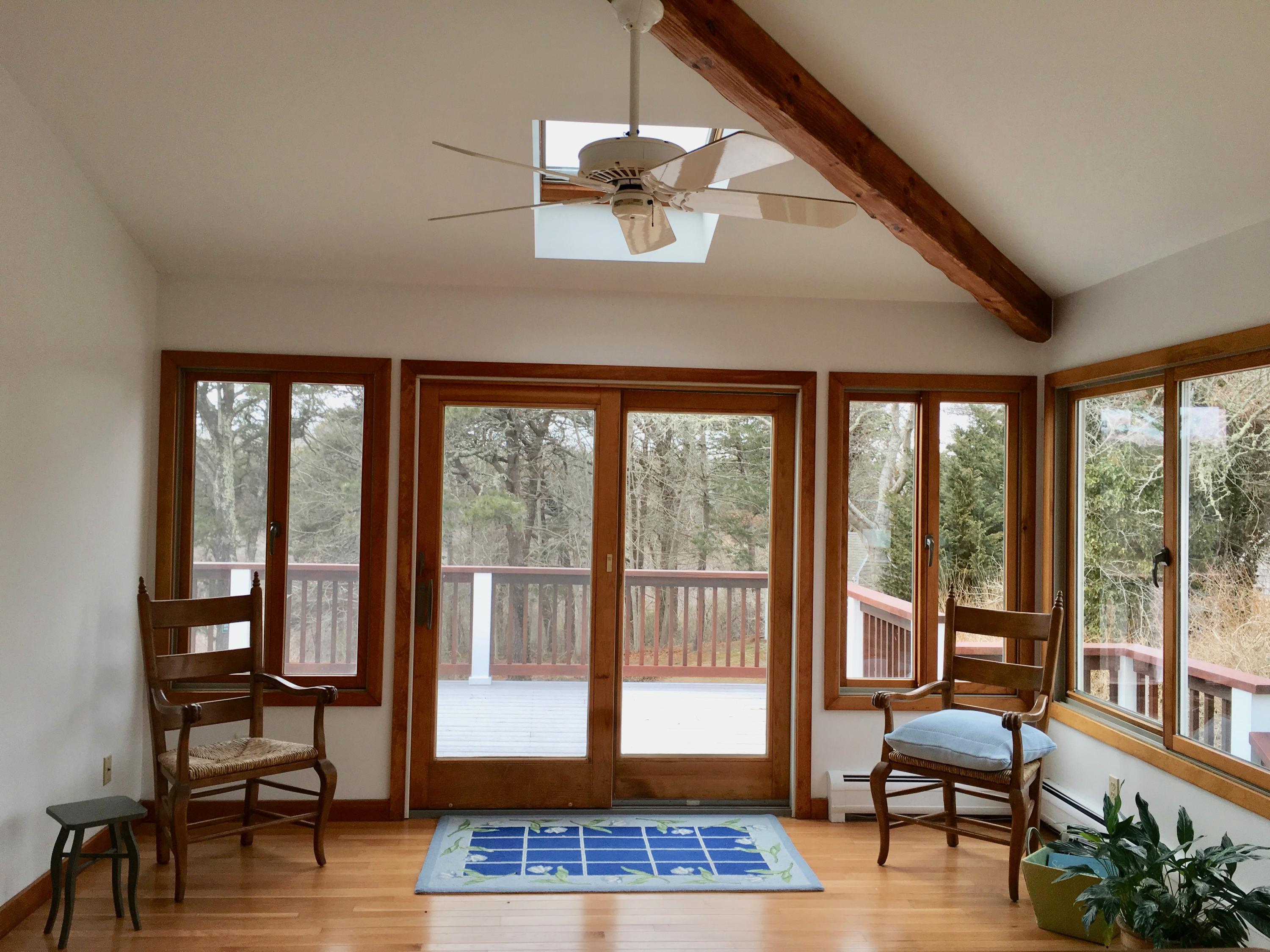 26 Champlain Road Orleans, MA 02653 - Photo 11 of 32 a living room with furniture and floor to ceiling windows