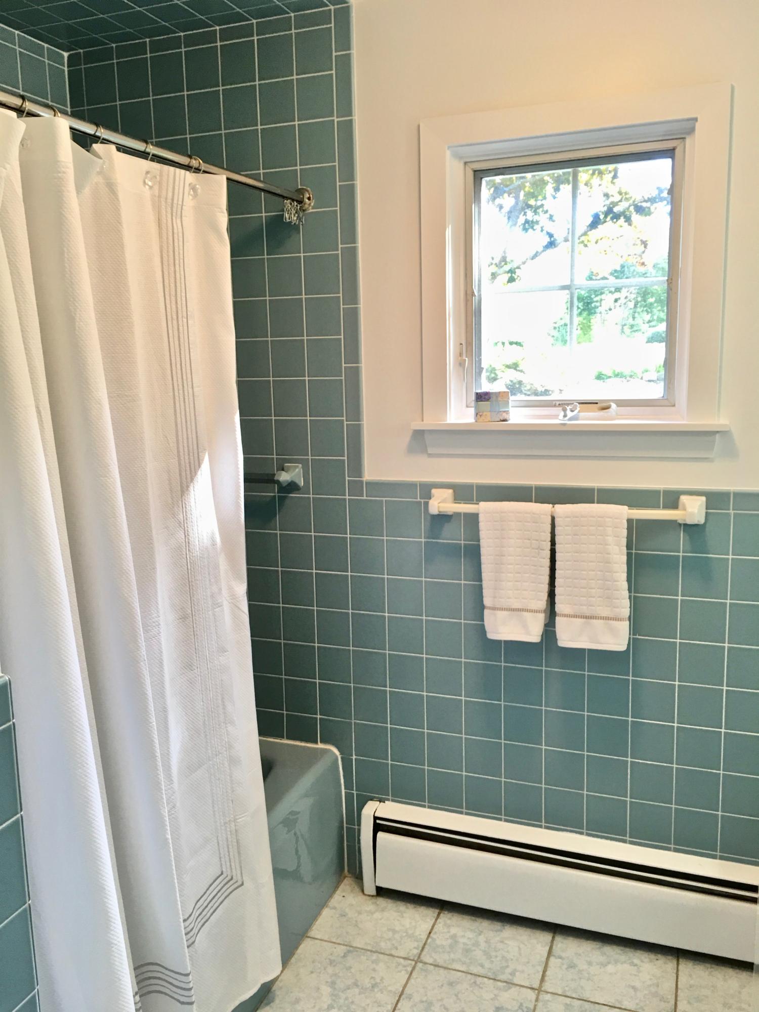 26 Champlain Road Orleans, MA 02653 - Photo 16 of 32 a bathroom with a window and a shower