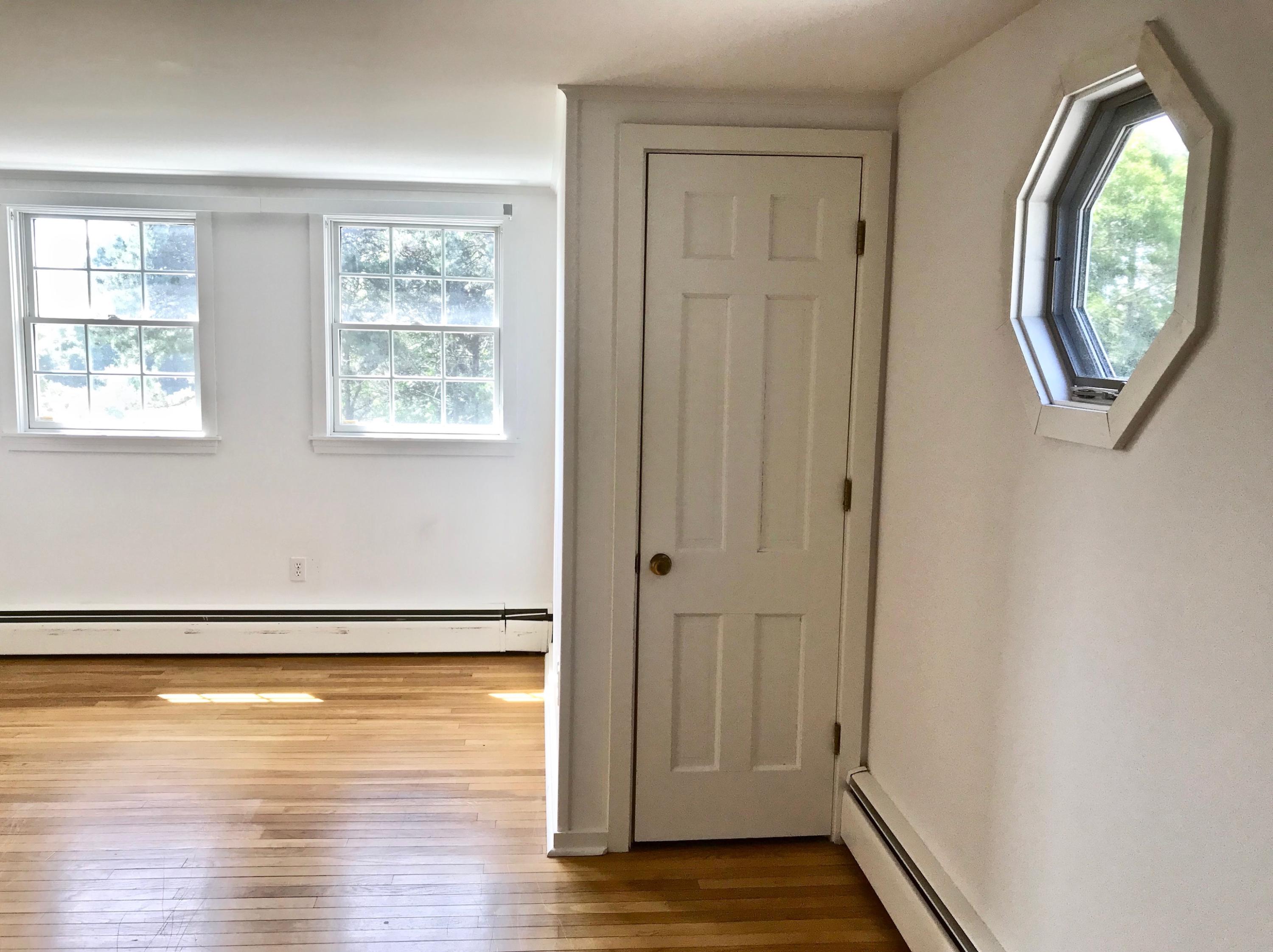 26 Champlain Road Orleans, MA 02653 - Photo 20 of 32 an empty room with wooden floor mirror and window