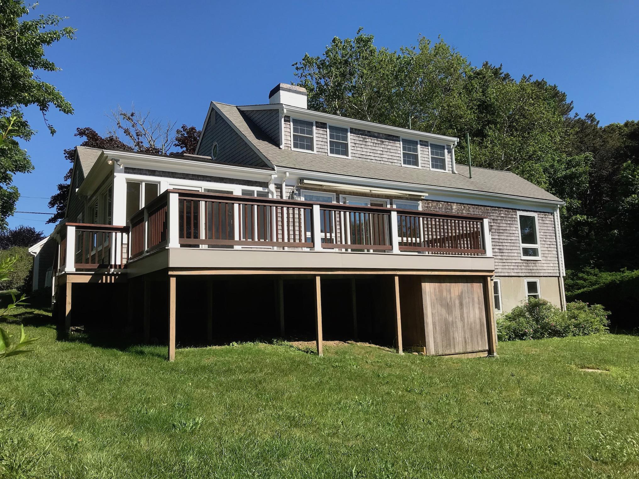 26 Champlain Road Orleans, MA 02653 - Photo 28 of 32 a front view of a house with a yard