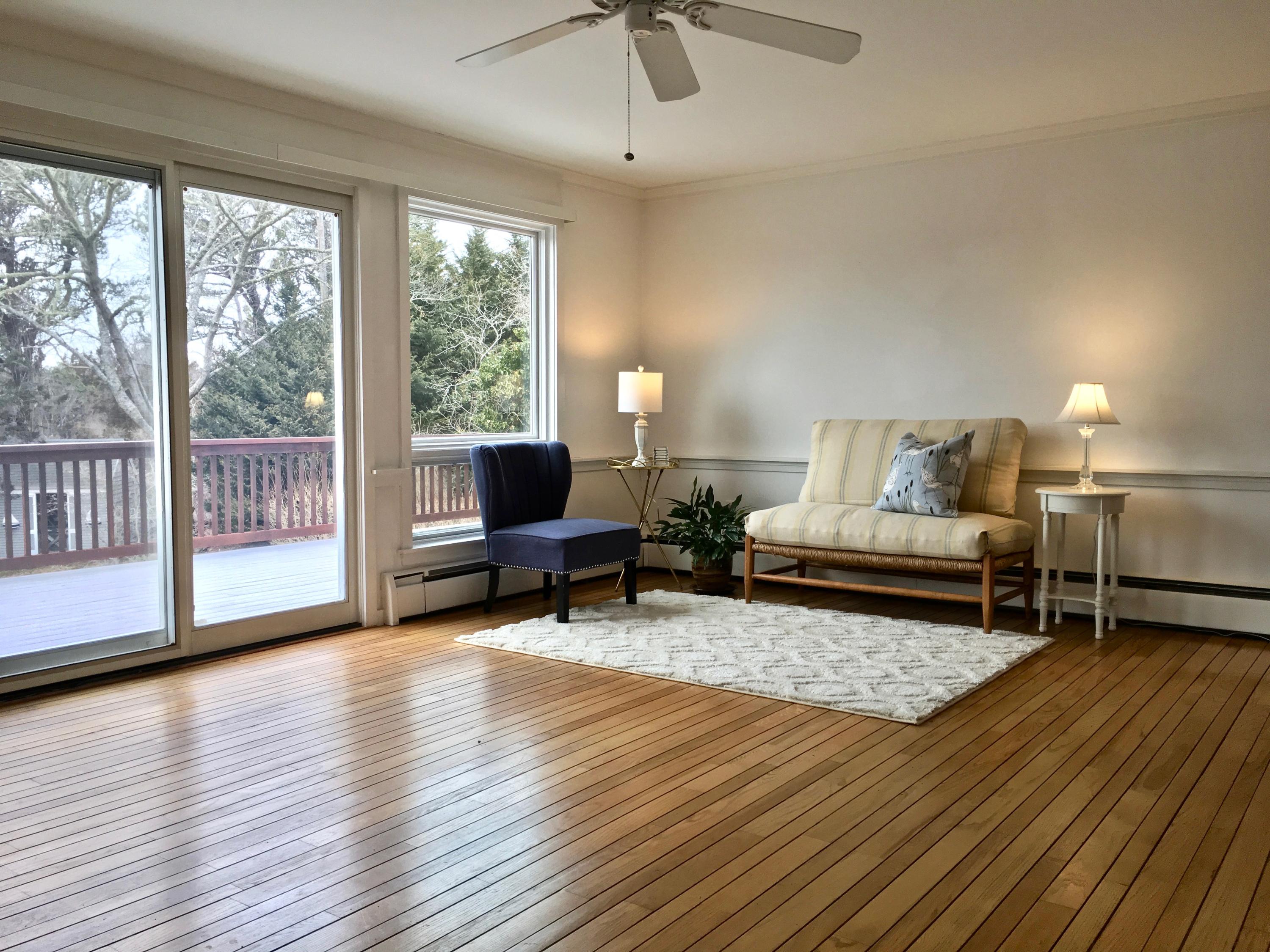 26 Champlain Road Orleans, MA 02653 - Photo 4 of 32 a living room with furniture and a table