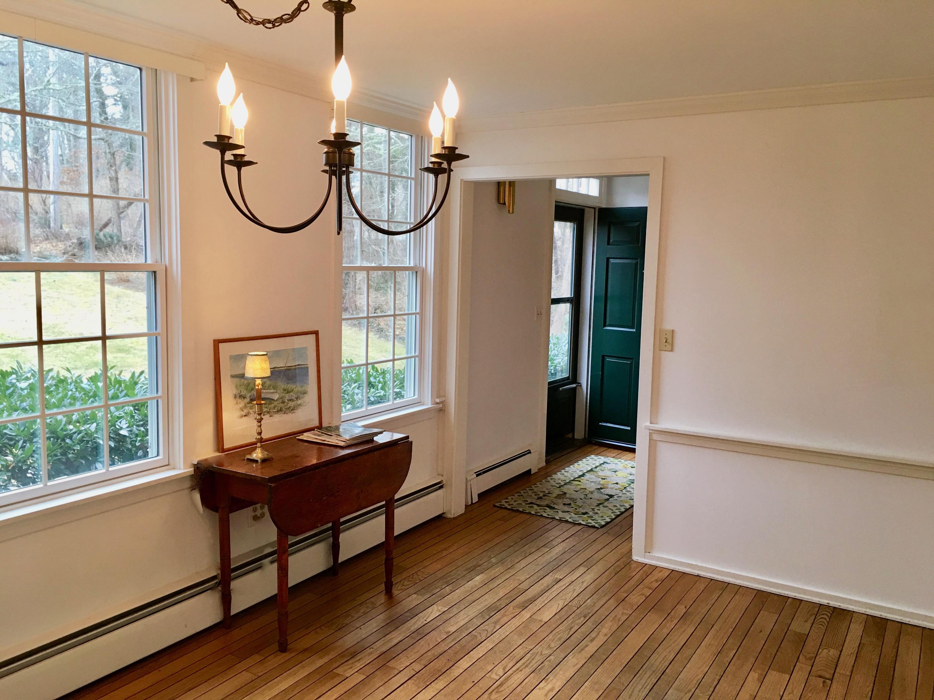 26 Champlain Road Orleans, MA 02653 - Photo 7 of 32 a view of a room with wooden floor and windows