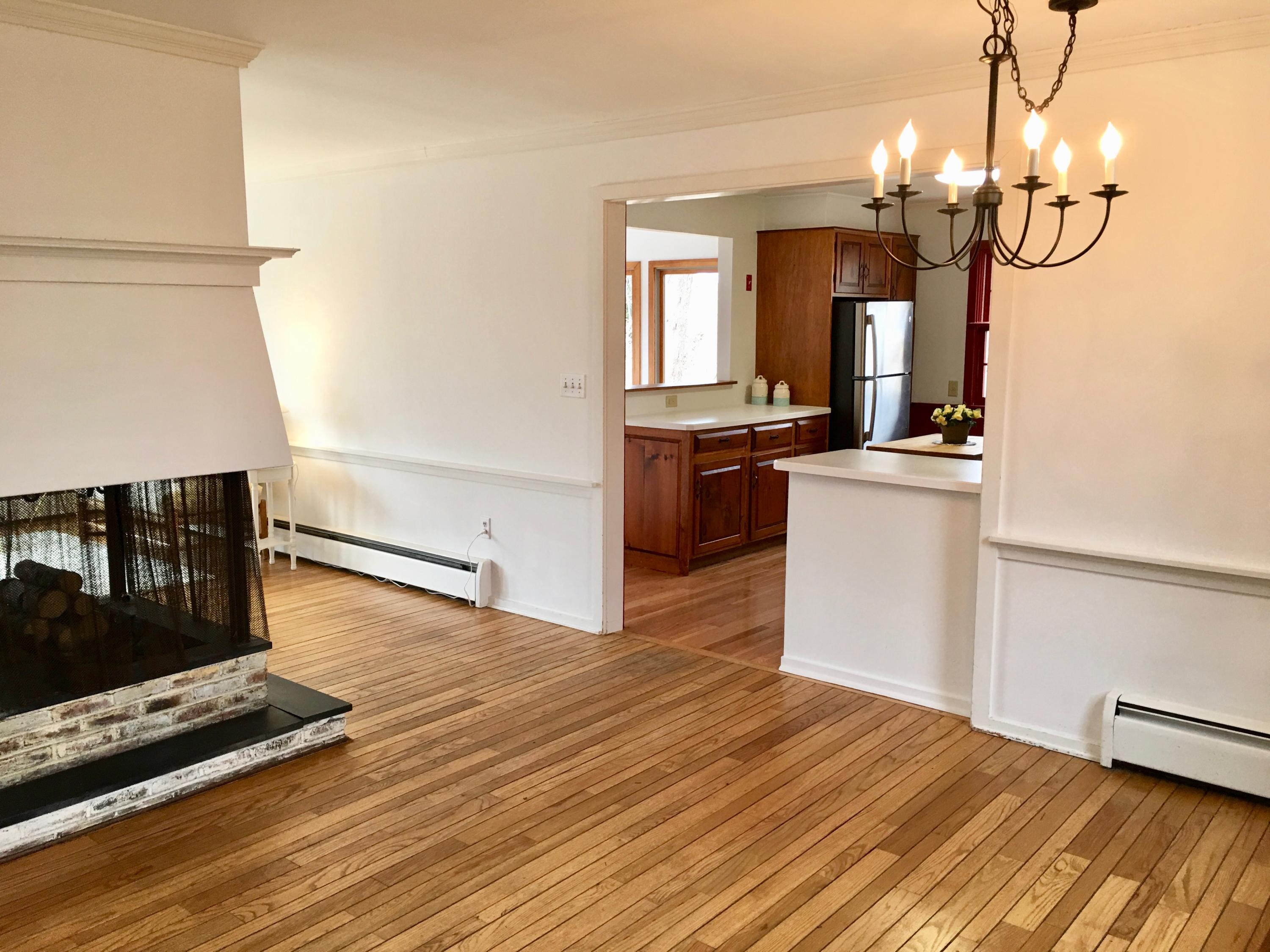26 Champlain Road Orleans, MA 02653 - Photo 8 of 32 a view of a room with wooden floor and kitchen view
