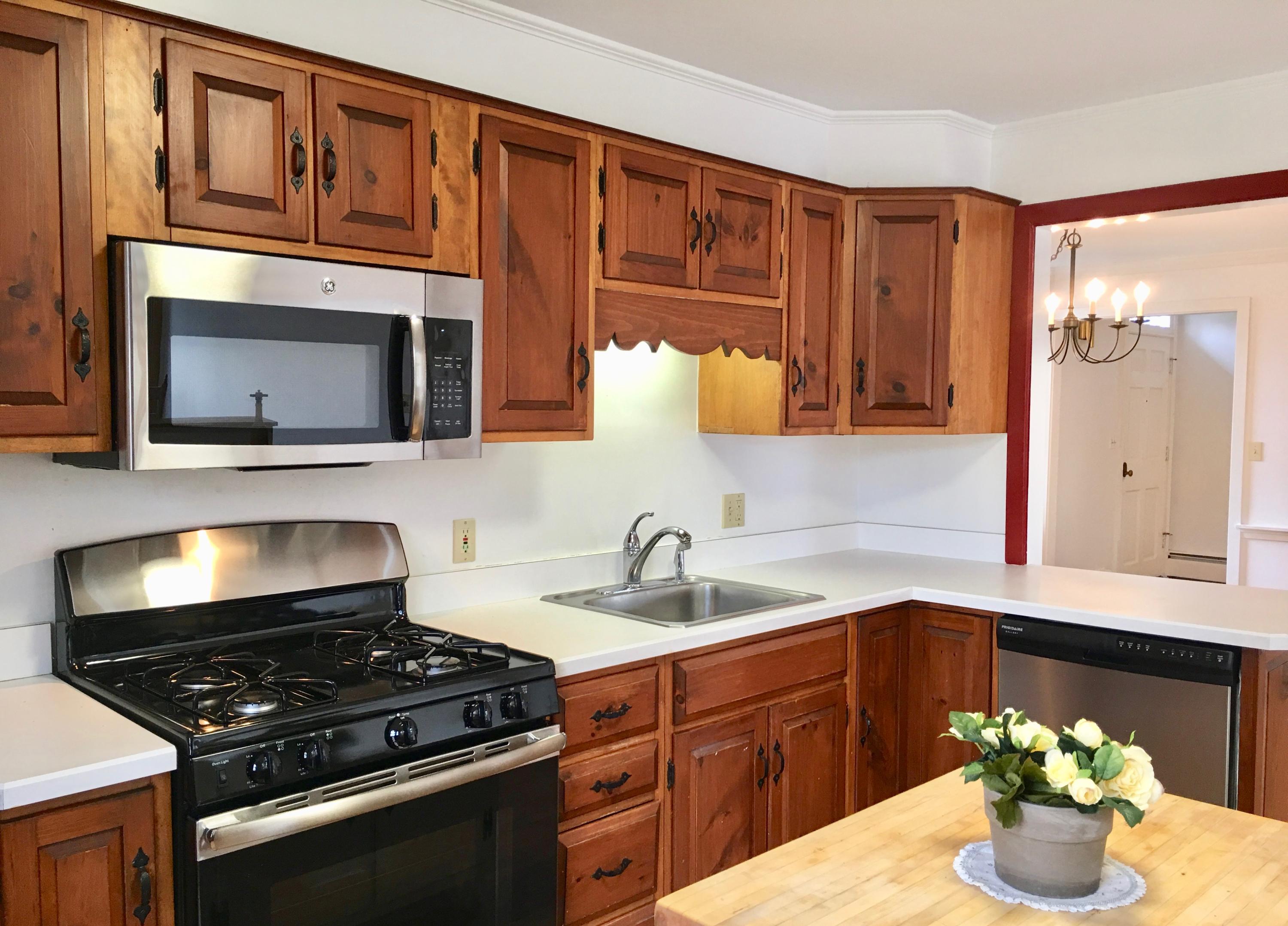 26 Champlain Road Orleans, MA 02653 - Photo 9 of 32 a kitchen with stainless steel appliances granite countertop a stove a sink and a microwave