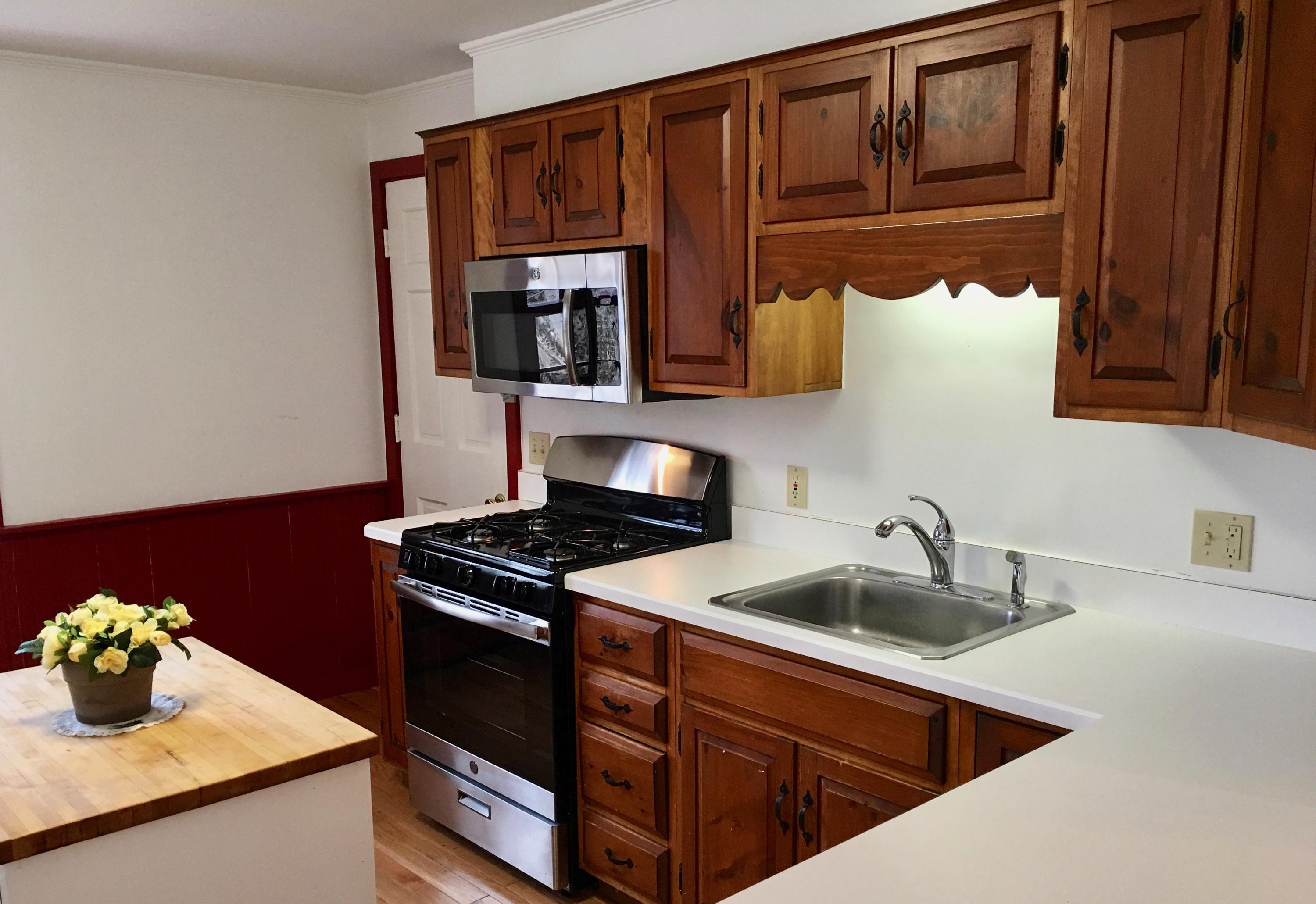 26 Champlain Road Orleans, MA 02653 - Photo 10 of 32 a kitchen with granite countertop a sink stainless steel appliances and cabinets