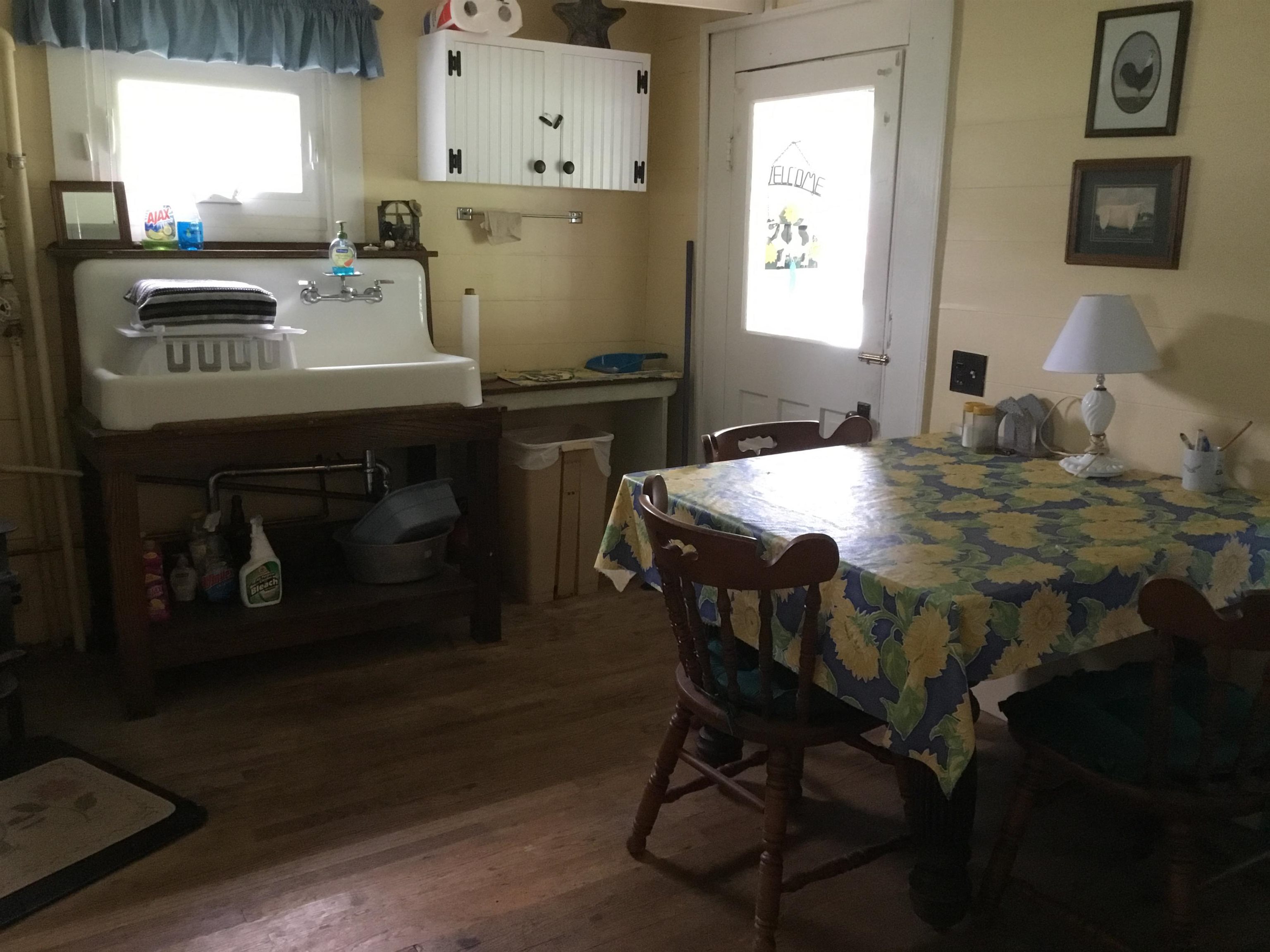 407 J Mallow Road Franklin, WV 26807 - Photo 19 of 39 a kitchen with a table chairs and a refrigerator