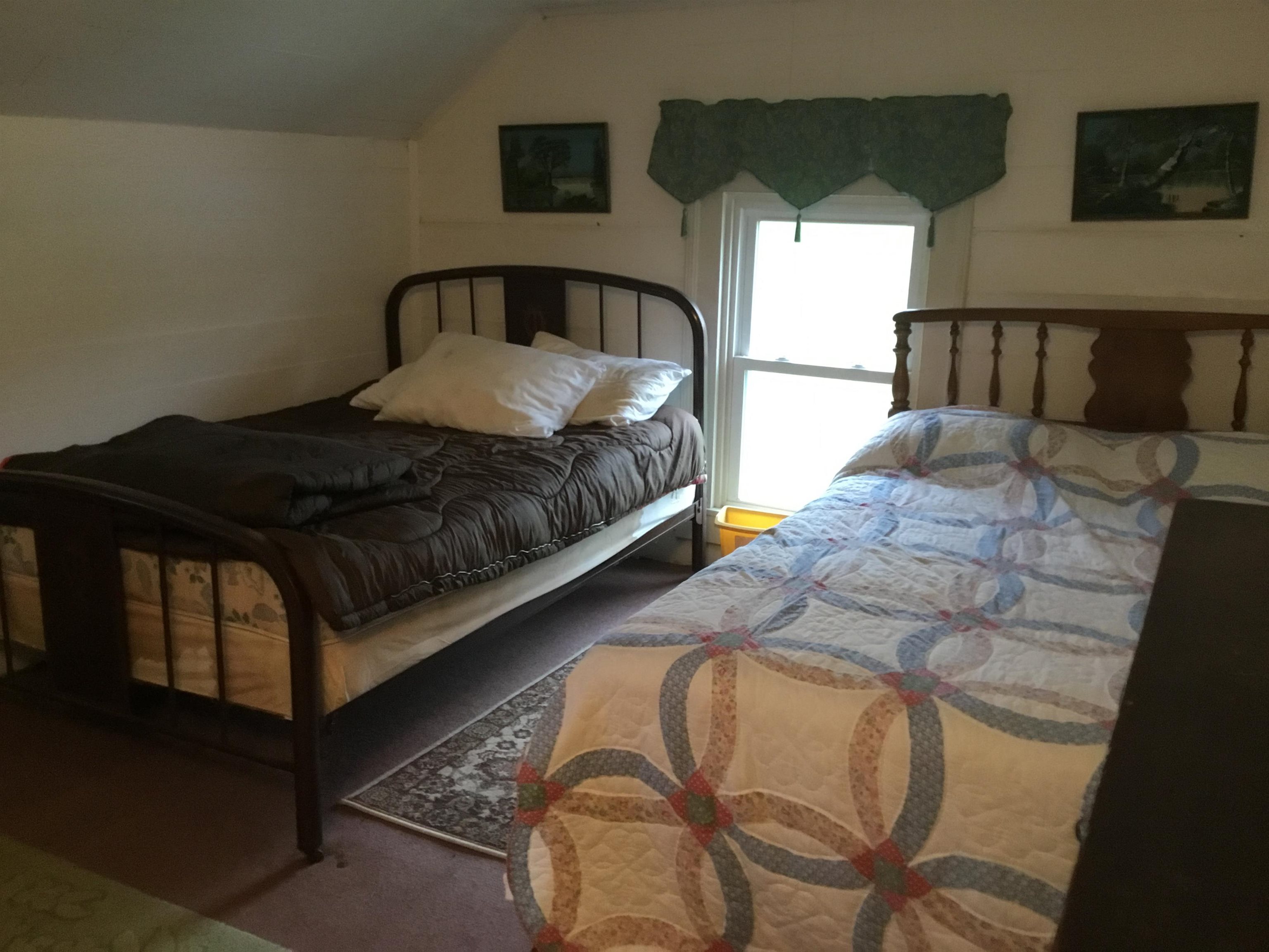 407 J Mallow Road Franklin, WV 26807 - Photo 30 of 39 a bedroom with bed and a night stand