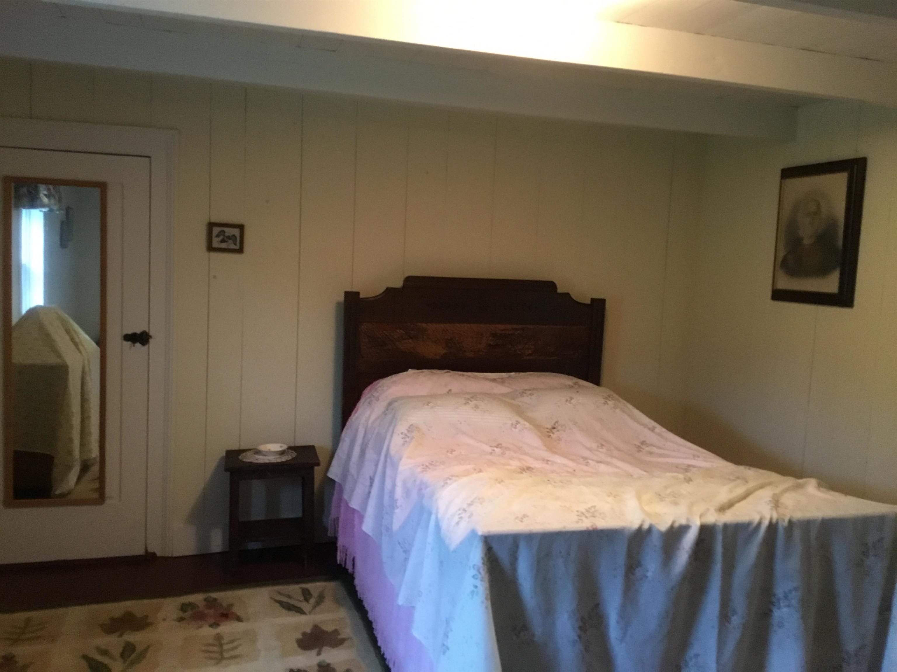 407 J Mallow Road Franklin, WV 26807 - Photo 35 of 39 a bed sitting in a bedroom next to a window with a wooden floor