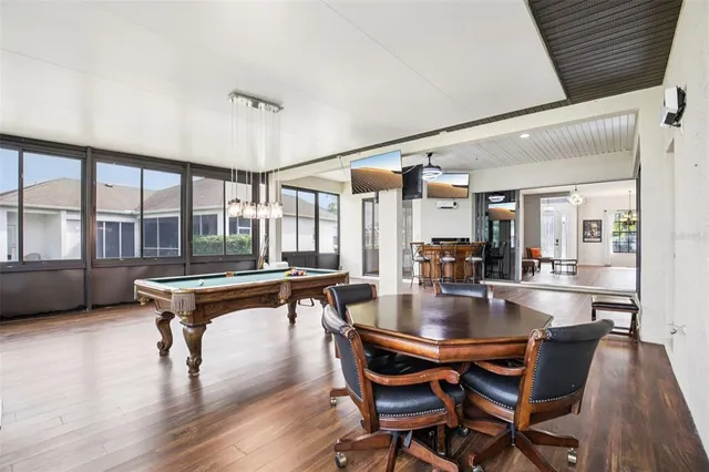 a dining room with furniture and wooden floor