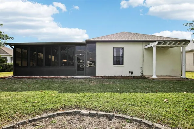 a view of a house with backyard and porch