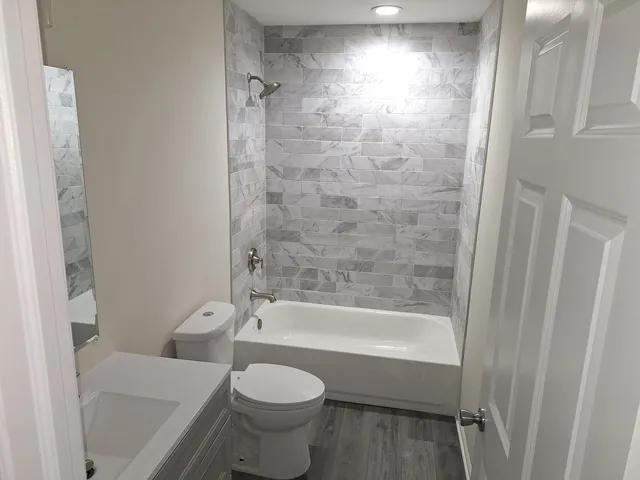 a bathroom with a bathtub and a toilet