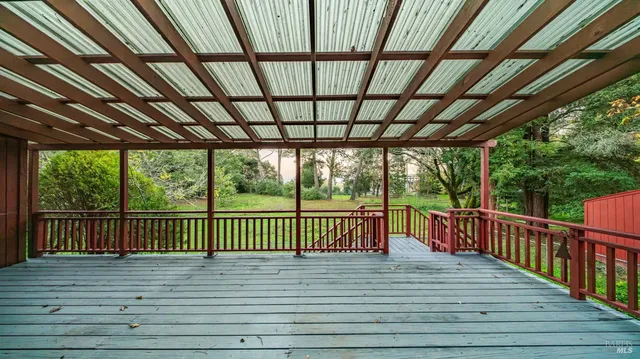 a view of green field with trees in the background