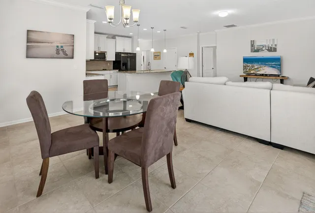 a living room with furniture and a ceiling fan