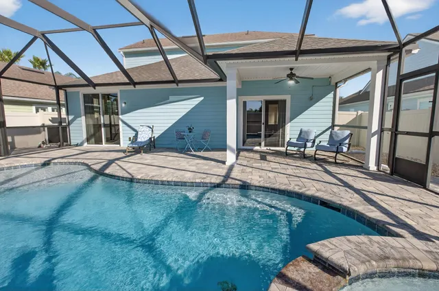 a roof deck with table and chairs and potted plants