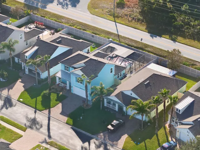 a kitchen with stainless steel appliances granite countertop a sink a stove a refrigerator a center island and cabinets