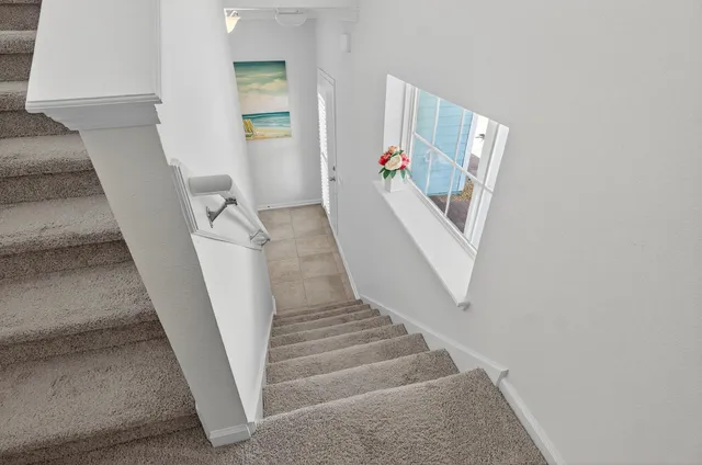 a bed sitting in a bedroom next to a lamp