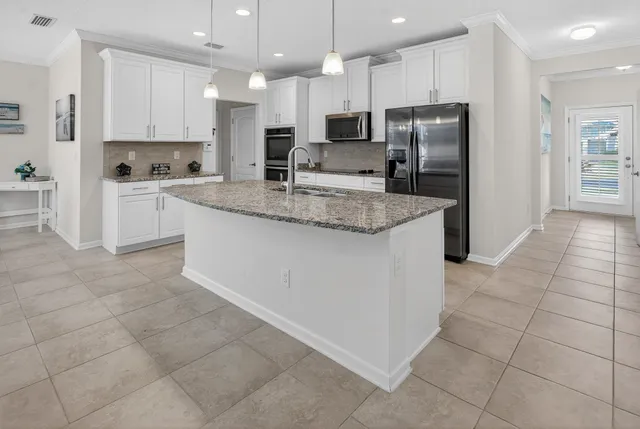 a living room with furniture and a ceiling fan