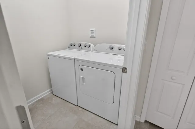 a view of backyard with a table and chairs under an umbrella