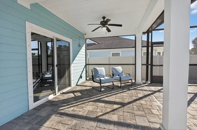 a view of a house with a small yard and wooden floor