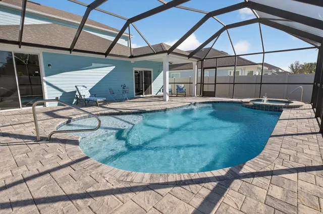 a front view of a house with a yard and potted plants