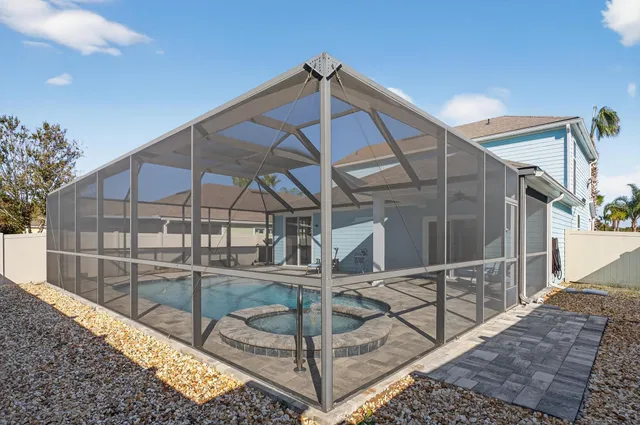 an aerial view of a house with a garden and swimming pool