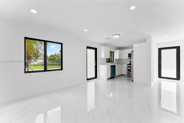 a view of a kitchen with a refrigerator and a window