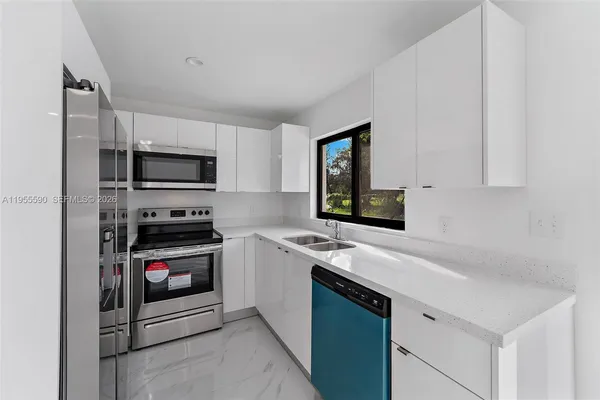 a kitchen with a sink stove and microwave