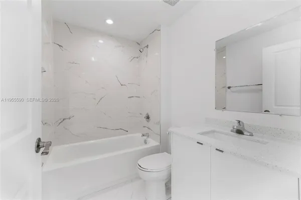 a bathroom with a sink toilet vanity and shower