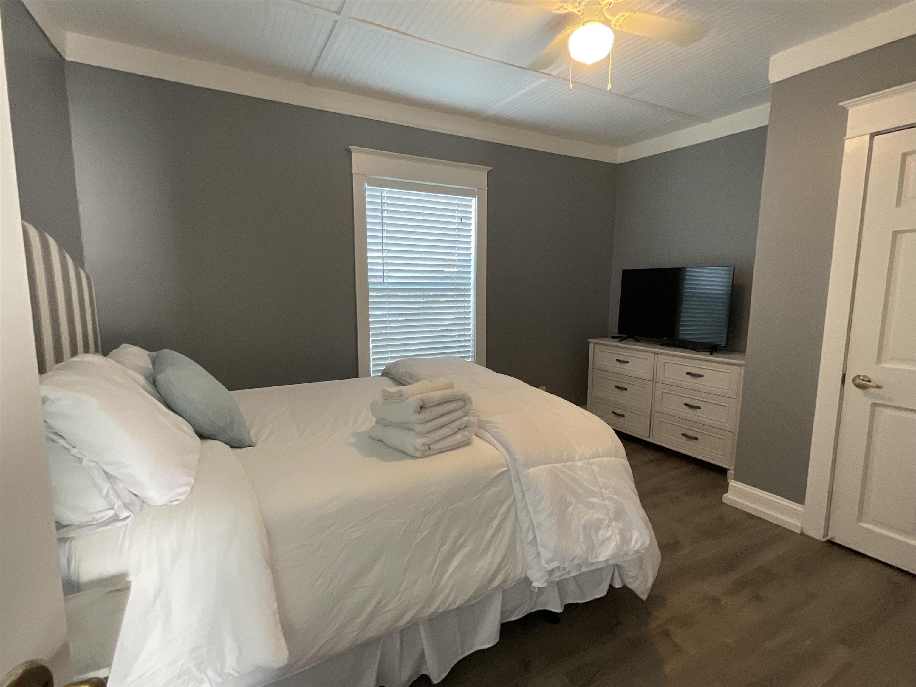 93 Keith Street, Unit A St. Augustine, FL 32084 - Photo 8 of 23 a bedroom with a bed and a tv