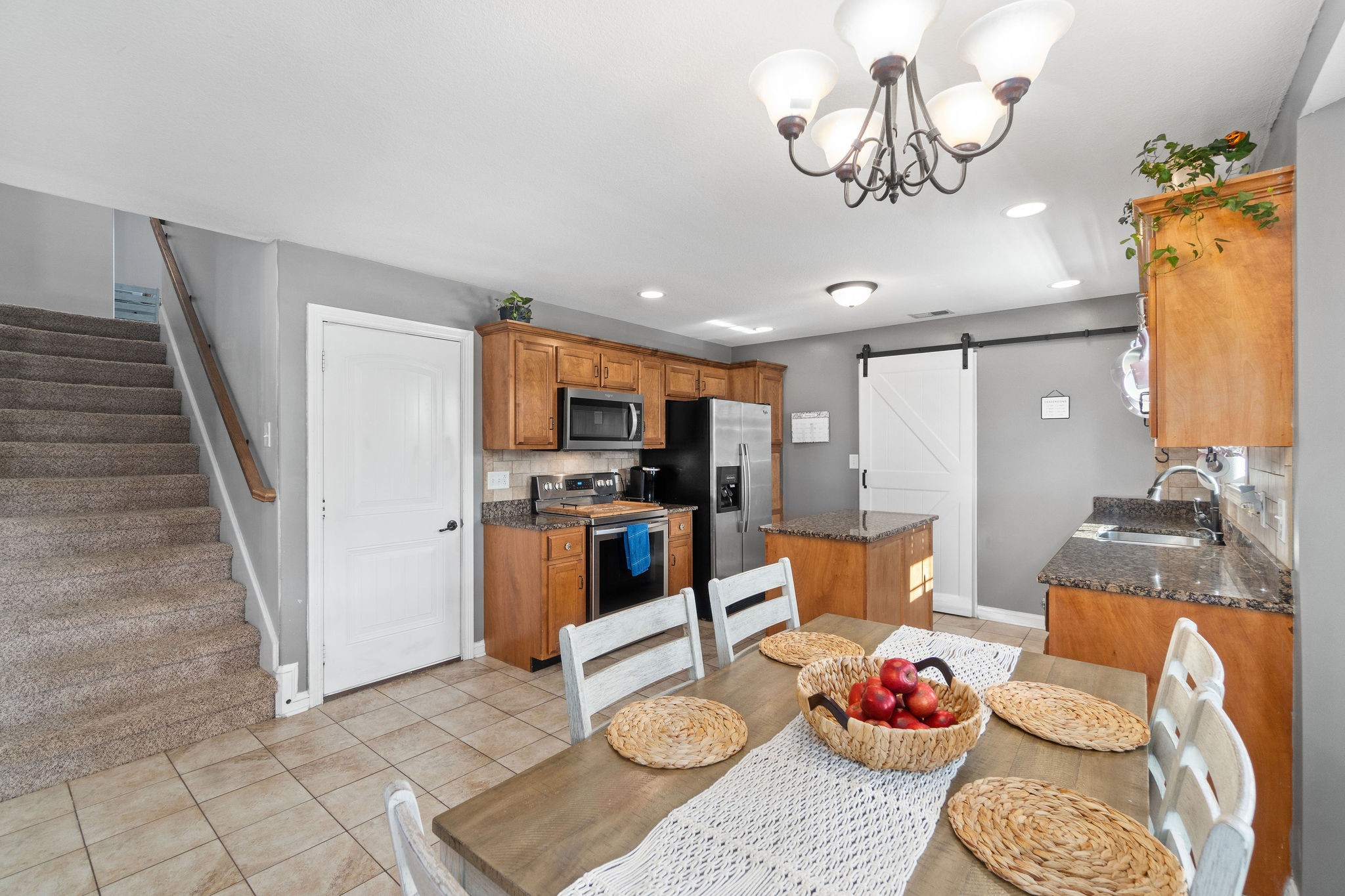 a living room with furniture and kitchen view
