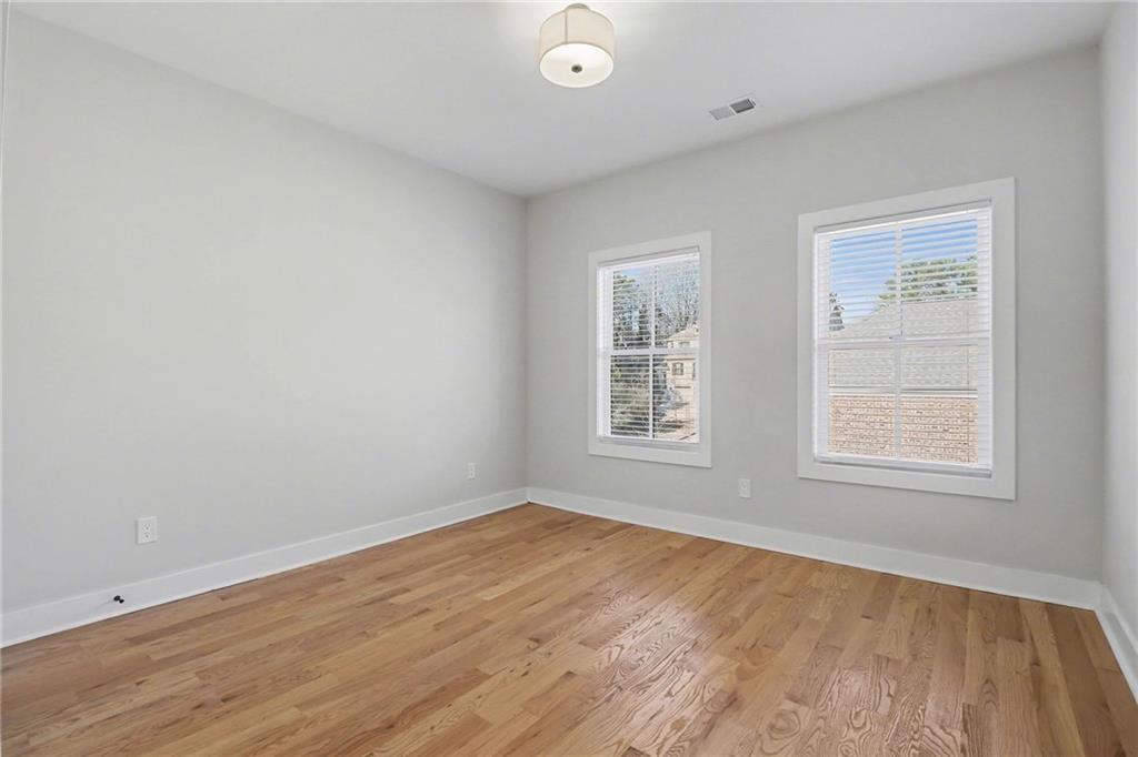 2149 Druid Flds Lane Decatur, GA 30033 - Photo 16 of 25 an empty room with wooden floor and windows