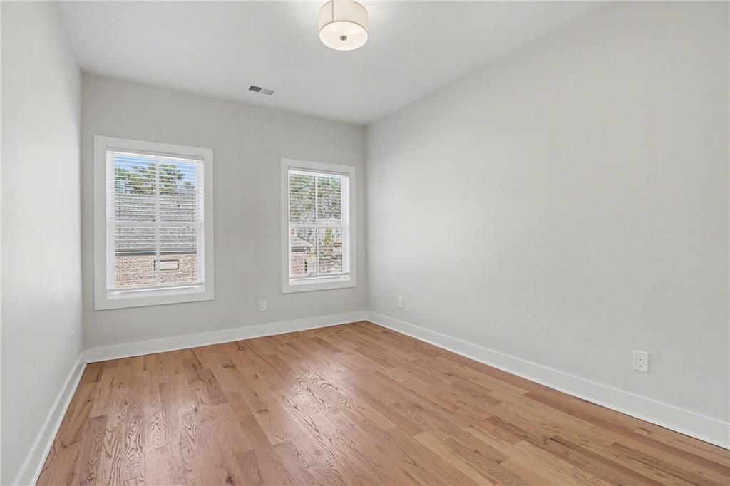 2149 Druid Flds Lane Decatur, GA 30033 - Photo 17 of 25 an empty room with wooden floor and windows