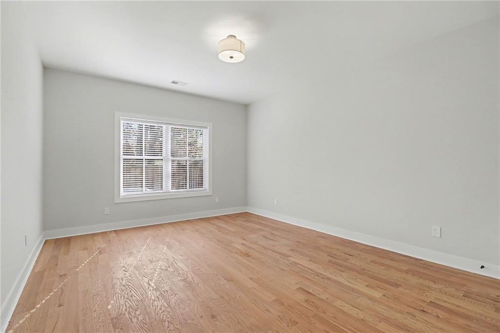 2149 Druid Flds Lane Decatur, GA 30033 - Photo 18 of 25 an empty room with wooden floor and windows